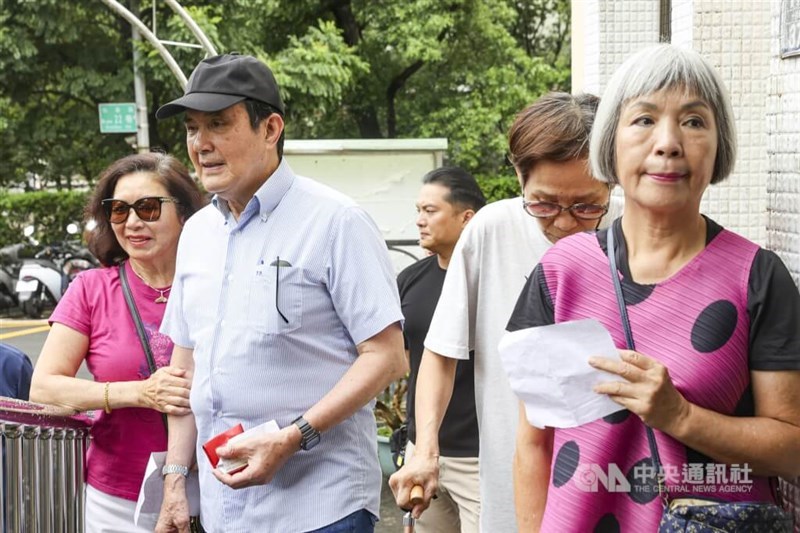 Former President Ma Ying-jeou (in light blue shirt) arrives to cast his vote at a polling station in Taipei. CNA photo July 26, 2025