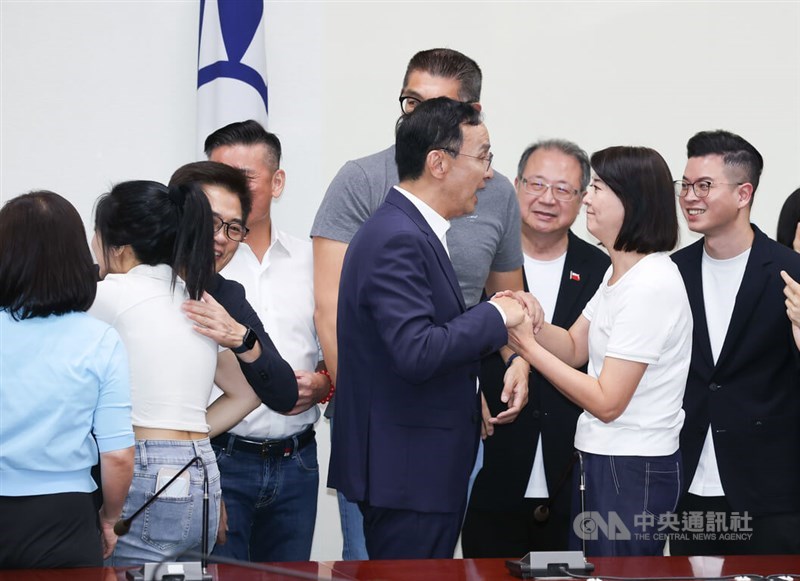 KMT Chairman Eric Chu (center) greets lawmaker Wang Hung-wei (front, second right) with excitement at the opposition party's headquarters in Taipei Saturday after she and her fellow legislators fended off recall campaigns against them. CNA photo July 26, 2025