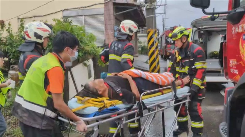 A woman rescued from under a collapsed house is being sent to the hospital by local firefighters and police. Photo courtesy of a reader Aug. 3, 2025