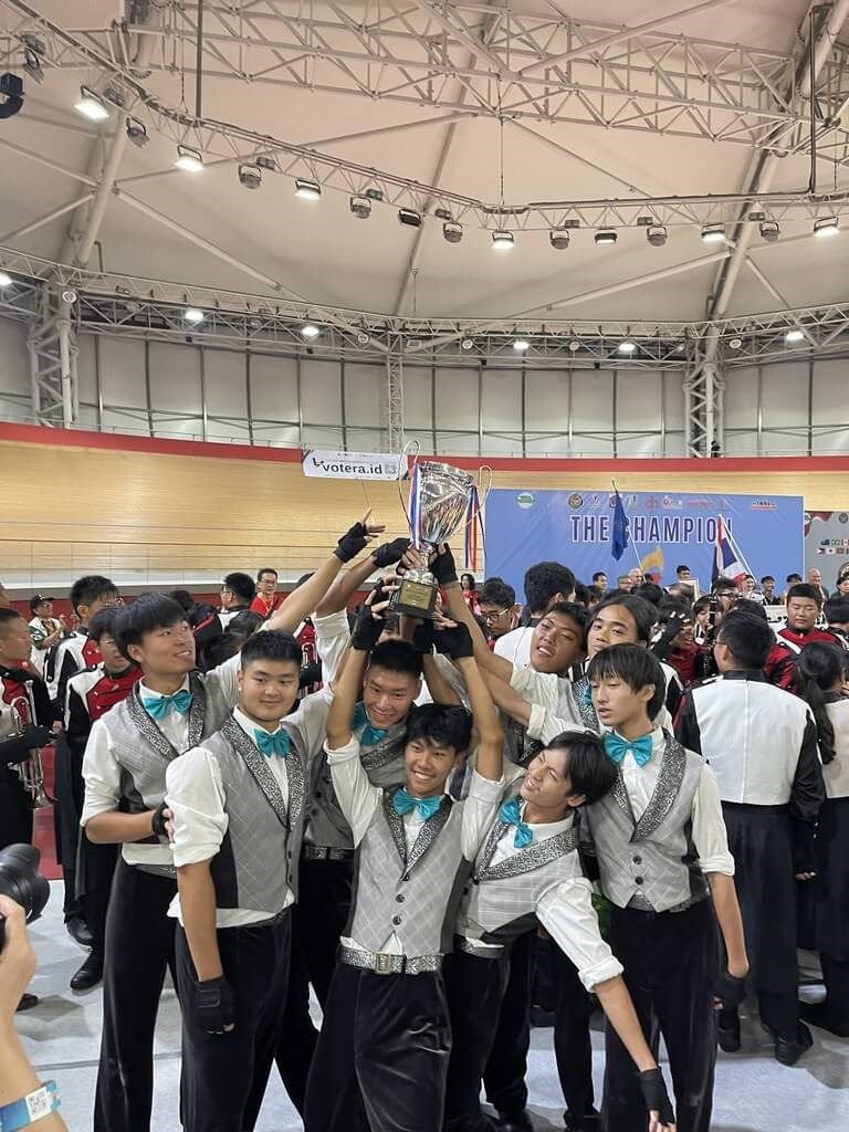 Members of the Taipei Municipal Chien Kuo High School Marching Band pose for a picture with their trophy. Photo courtesy of the Taipei Municipal Chien Kuo High School Marching Band Parent Fan Club Aug. 11, 2025