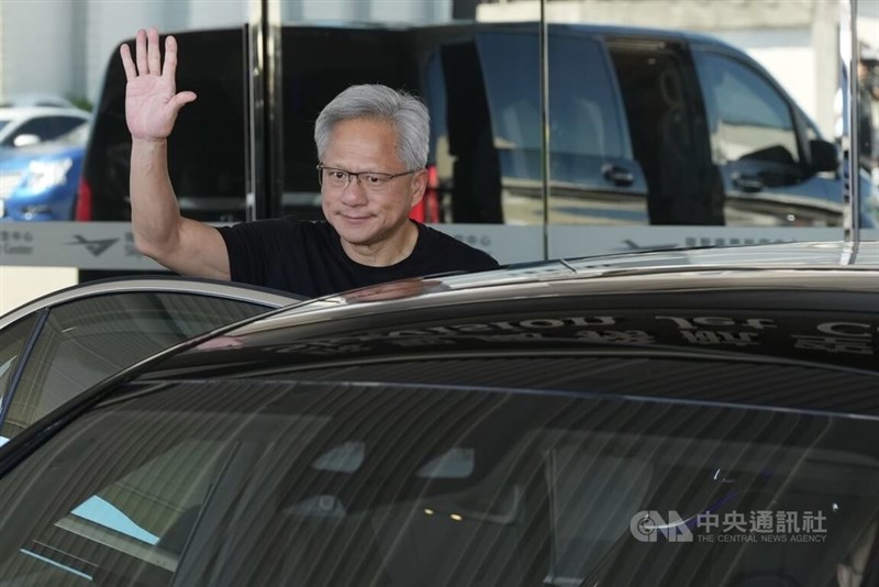 Nvidia CEO Jensen Huang waves to reporters at Taipei Songshan Airport in Taipei Friday. CNA photo Aug. 22, 2025