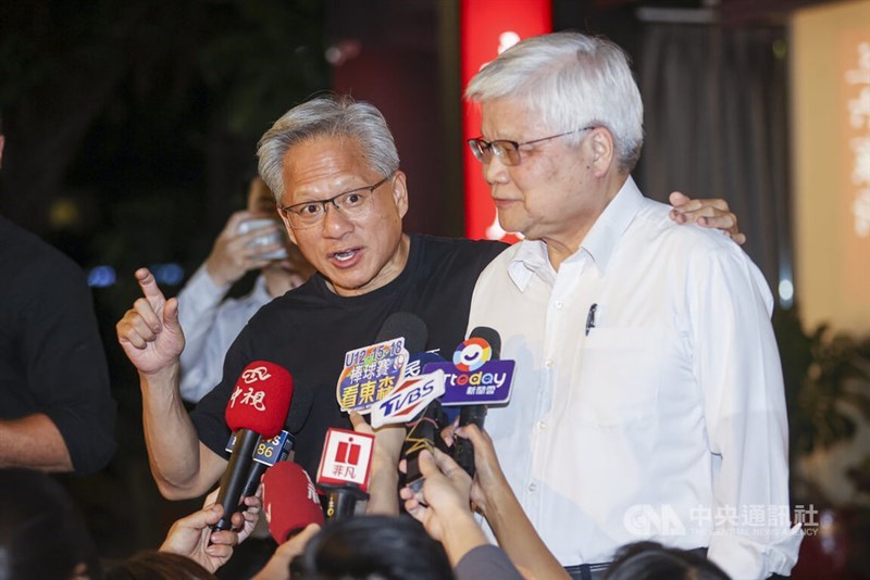 C.C. Wei (right) and Nvidia founder and CEO Jensen Huang (left) speak to reporters after dinner at a Taipei restaurant on Friday night. CNA photo, Aug. 22, 2025