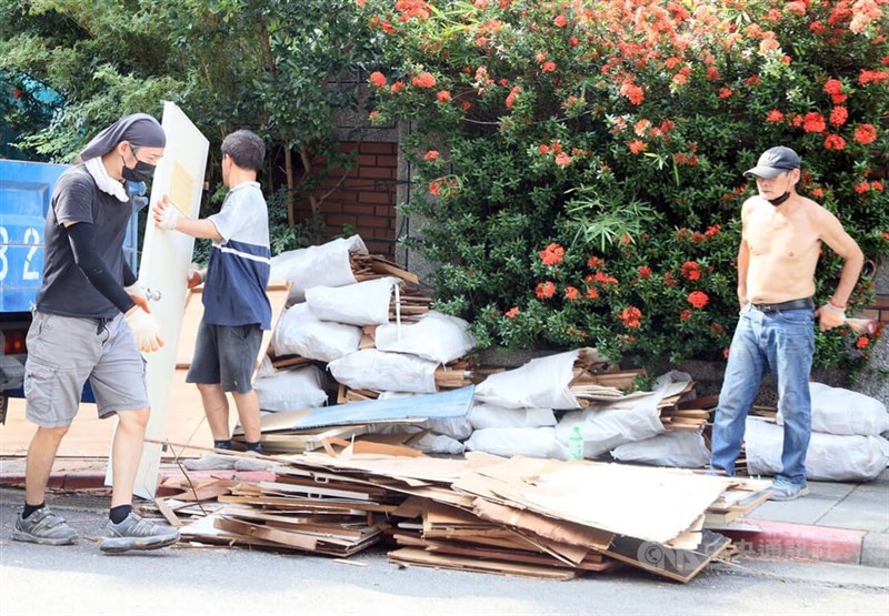 Local workers perform manual labor at a worksite. CNA file photo