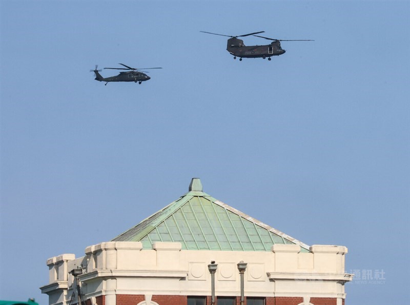 A UH-60M Black Hawk helicopter and a CH-47SD Chinook transport helicopter flying over the Presidential Office in a rehearsal organized by Taiwan's military ahead of the National Day of the Republic of China (Taiwan) flyby performance on Oct. 10.