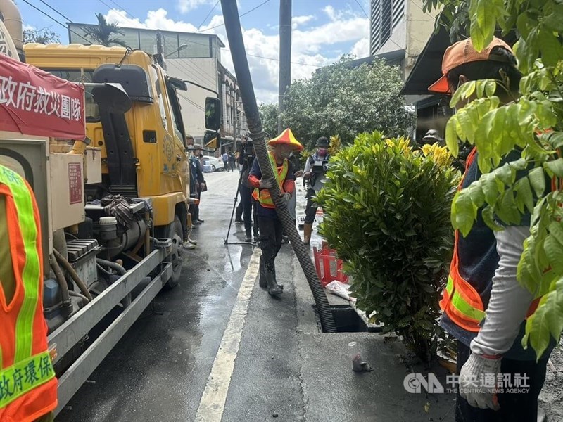 A sanitation worker uses a hose to remove mud from a sewer in Guangfu Township, Hualien County, on Monday. CNA photo Oct. 6, 2025