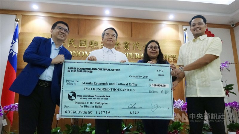 Taiwan's representative to the Philippines, Wallace Chow (left), representing the Taiwanese government, donates US$200,000 to the Philippines. The donation was received by Cherbett Maralit, deputy resident representative of the Manila Economic and Cultural Office, in Manila, Philippines, on Tuesday. CNA photo Oct. 14, 2025