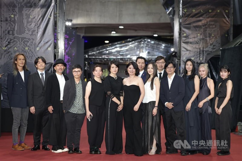 Yen Yi-wen, director of Born for the Spotlight, strolls down the red carpet in Taipei with her crew on Saturday. CNA photo Oct.18, 2025