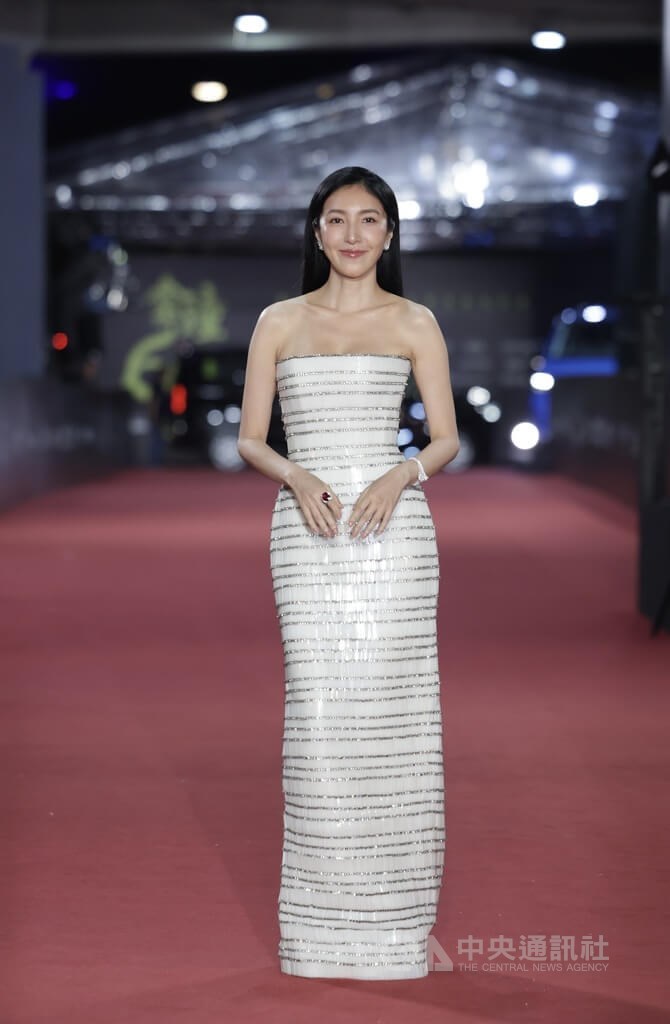 Cheryl Yang, one of the leading actresses of "Born for the Spotlight," steps onto the red carpet in a white bandeau dress in Taipei on Saturday. CNA photo Oct. 18, 2025