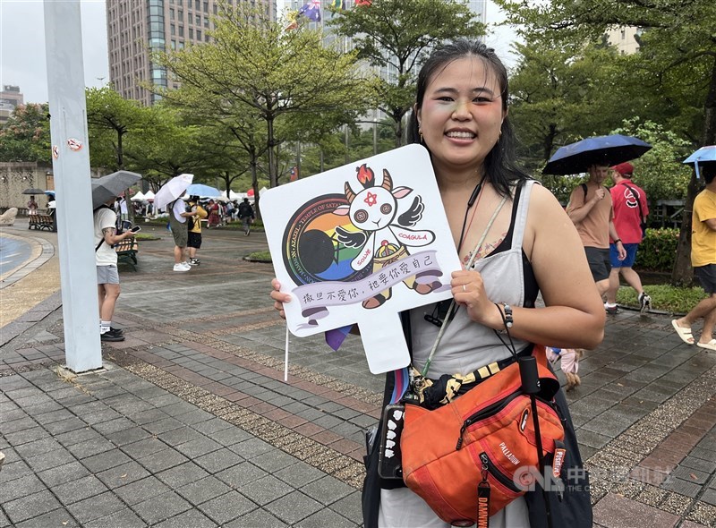 Taiwanese participant Ryu holds a placard that reads “Satan doesn’t love you; He wants you to love yourself” at Taiwan Pride in Taipei on Saturday. CNA photo Oct. 25, 2025