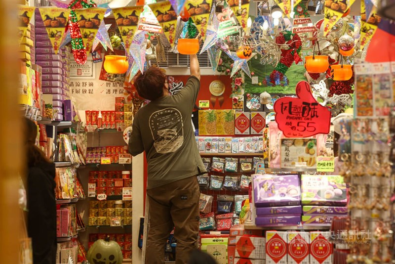 An employee arranging displays inside a shop in Taipei's Ximending shopping district. CNA photo Nov. 10, 2025