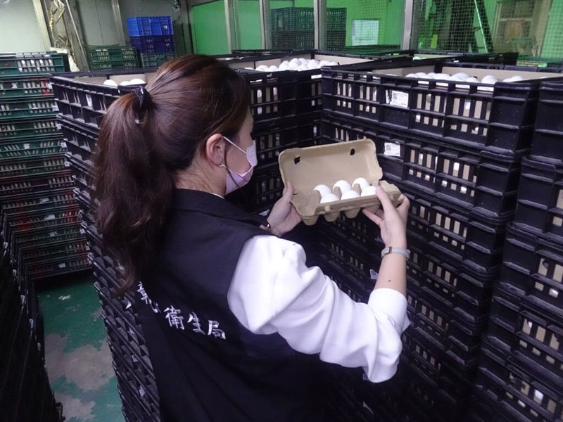 A health official inspects eggs stored at a warehouse in Changhua County on Sunday. Photo courtesy of the Changhua County government