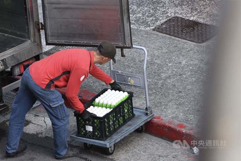 A worker transports eggs on a street in Taipei's Ximending district Monday. CNA photo Nov. 24, 2025