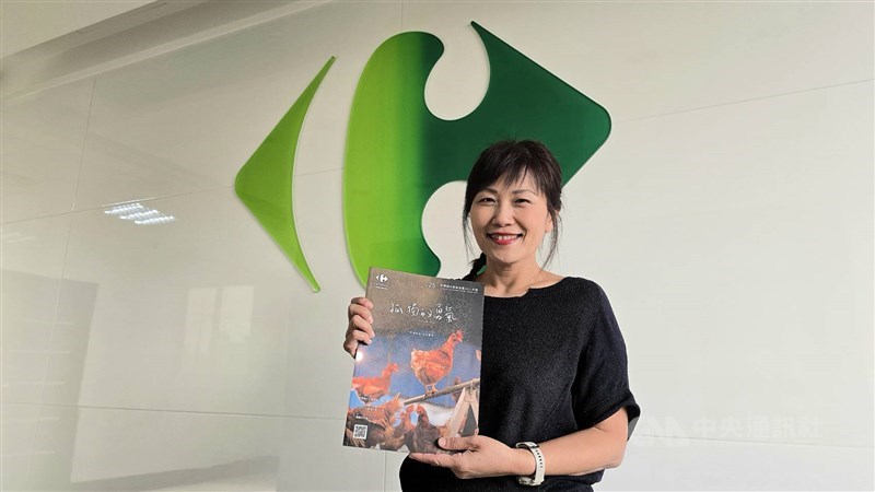 Marilyn Su holds up a copy of Carrefour's 2021 annual report. CNA photo Nov. 30, 2025