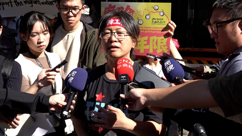 Wu Jing-ru (center), spokesperson for Migrant Empowerment Network in Taiwan, speaks to reporters during a rally in Taipei on Sunday. CNA photo Dec. 7, 2025