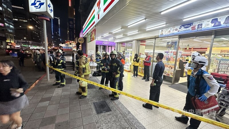 Emergency responders set up yellow caution tapes and standby outside Exit M7 at MRT Taipei Main Station on Friday night. CNA photo Dec. 19, 2025