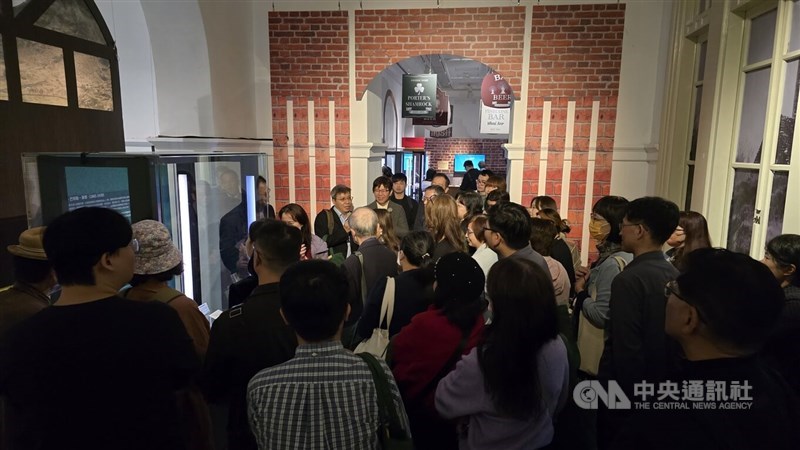 Visitors gather around an exhibition piece at the "Love Loves to Love Ireland: Extremely Distant and Incredibly Close" exhibition, held Friday at the National Museum of Taiwan Literature in Tainan. CNA photo Dec. 19, 2025