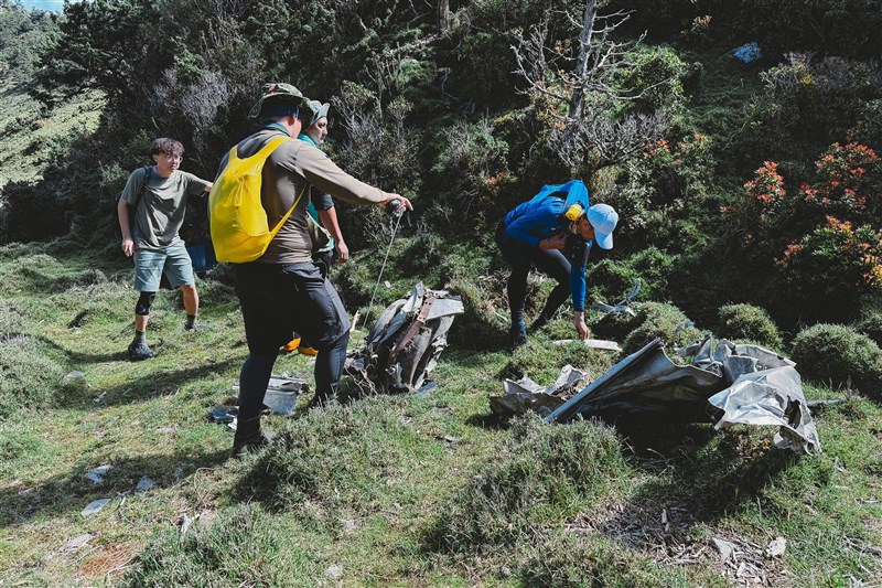 Members of the Ministry of the Interior team inspect debris of the crashed B-24 bomber on Sancha Mountain. Photo courtesy of Military News Agency