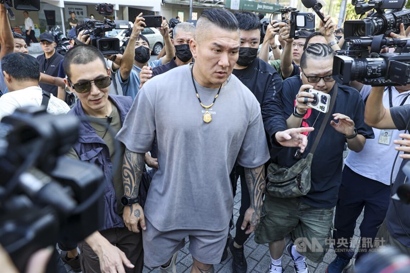 Internet influencer Holger Chen (center) is escorted by police to the Criminal Investigation Bureau on Oct. 15, 2025. CNA file photo
