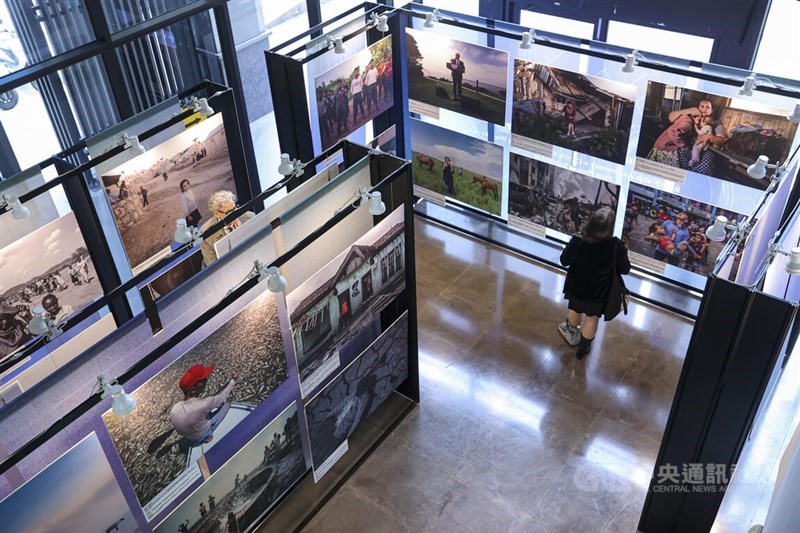 A woman stands amid a photo gallery at the exhibition “Shooting the World of Tomorrow” in Taipei on Monday. CNA photo Jan. 12, 2026