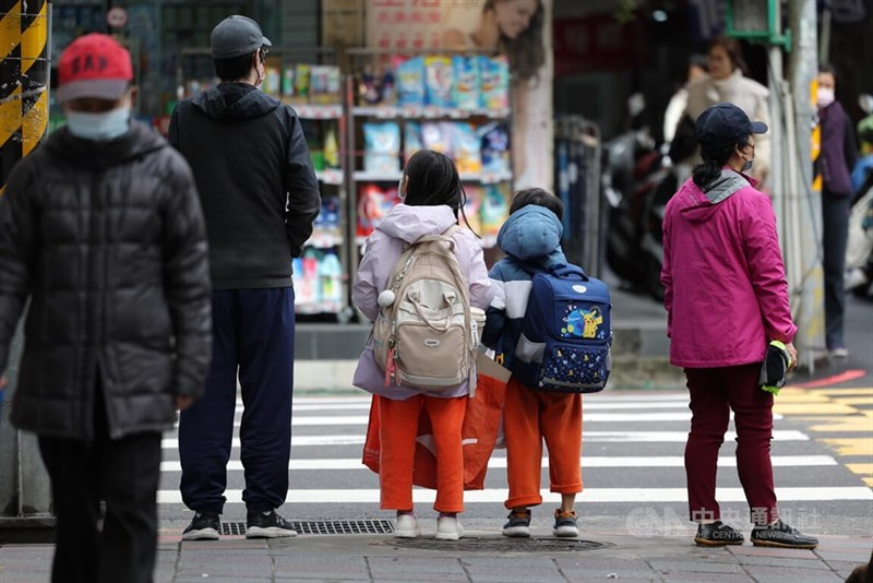 Two children wait to pass a pedestrian crossing. CNA file photo for illustrative purpose only