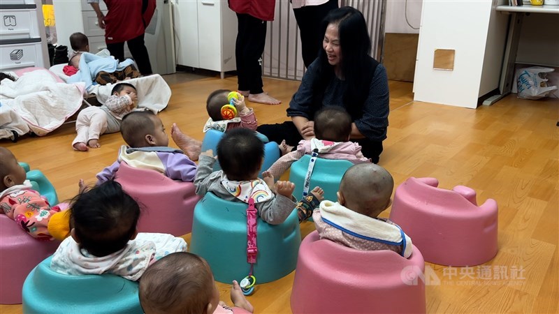 Harmony Home founder Nicole Yang (in black) plays with some undocumented children at a shelter run by the NGO in Taipei in late January. CNA photo Feb. 5, 2026