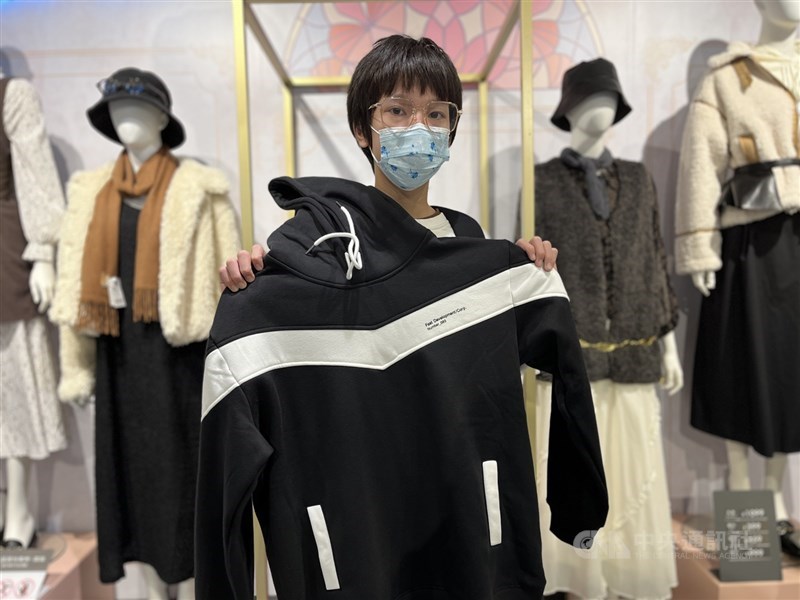 Snow Wu holds up a black hoodie he chose for Lunar New Year visits during NET’s closed-store shopping session in Taipei in late January. CNA photo Feb. 14, 2026