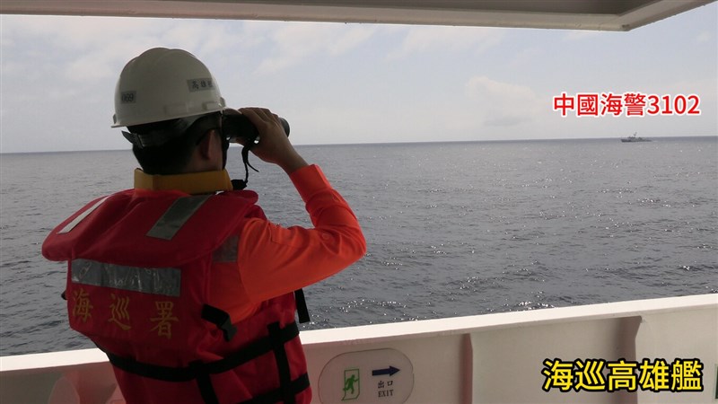 A Taiwanese Coast Guard Administration officer aboard the patrol ship Kaohsiung monitors a China Coast Guard vessel, designated 3102, near Taiwan-controlled Dongsha Island in the South China Sea on Thursday. Photo courtesy of CGA's Dongsha-Nansha Branch