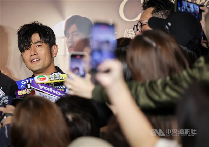 Jay Chou (back left) is surrounded by the media at a press event in Taipei on Tuesday. CNA photo March 25, 2026