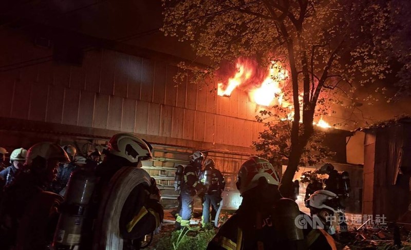 Firefighters extinguish a blaze at a corrugated metal factory in Taipei’s Nangang District early Saturday. Photo courtesy of local authorities