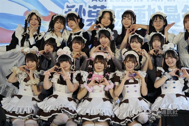 Staff at maid cafes take a group photo at the stage of the A.C.F. 2026 in Taipei on Friday. CNA photo April 3, 2026