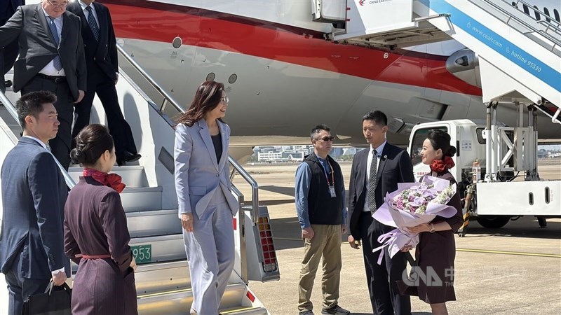 Cheng (third left) walks down from the aircraft to accept a bouquet in Shanghai on Tuesday. CNA photo April 7, 2026.