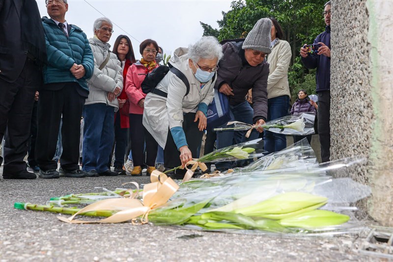 People lay down flowers in observation of a White Terror era event in this CNA file photo