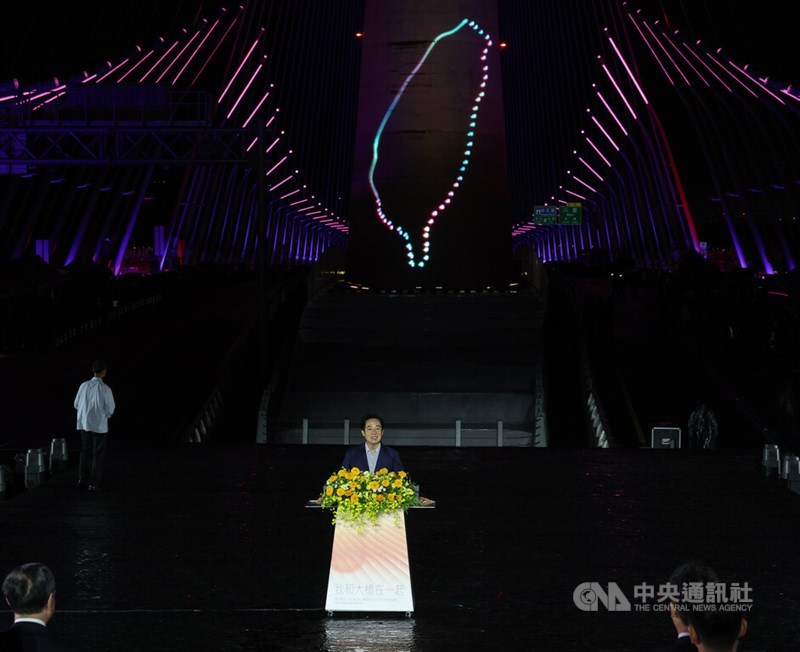 Special lighting in the shape of Taiwan illuminates the background as President Lai Ching-te speaks at an inauguration ceremony for the Danjiang Bridge in New Taipei on Saturday. CNA photo May 9, 2026
