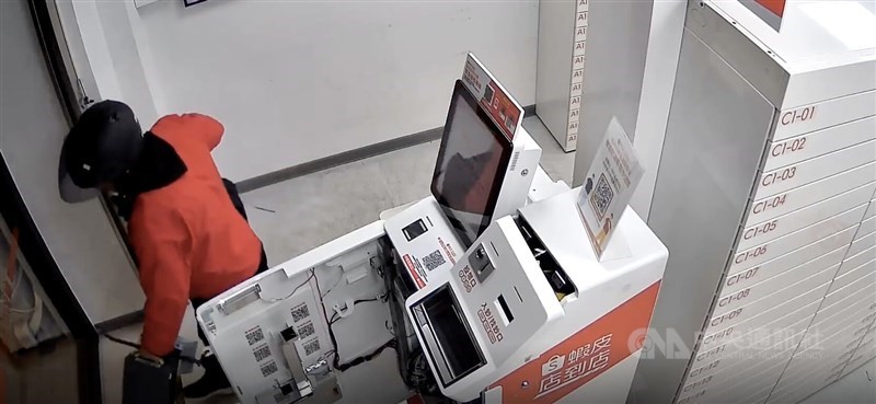A still from surveillance footage that shows one of the suspects inside a Shopee self-pickup store and a payment machine that has been forced open. CNA photo May 12, 2026