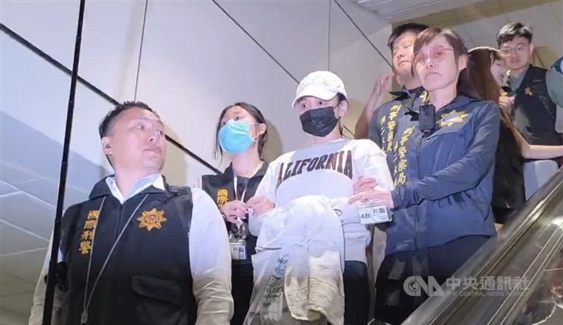 Criminal Investigation Bureau agents escort suspect Johanne Liou (third right) at Taiwan Taoyuan International Airport on Thursday. CNA photo June 4, 2026