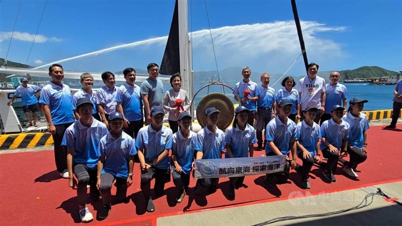 Students from Yue-Ming Elementary and Junior High School in Yilan County and officials pose for a group photo at Suao Port on Friday before the students' departure for Japan's Okinawa island chain, with Vice Premier Cheng Li-chiun (second row, sixth left) attending the send-off ceremony. CNA photo July 3, 2026