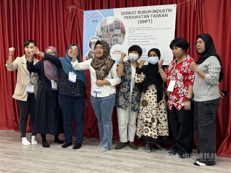 Fajar (fourth left), chairperson of Indonesian workers’ solidarity group GANAS Community, poses with other members of the group during an event in September 2024. CNA file photo