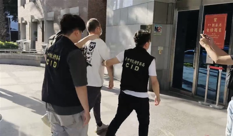 Taichung police officers escort Liu (in white shirt), who is suspected of assaulting Indo-Pacific Strategy Thinktank CEO Akio Yaita, after arresting him at Taichung International Airport on Monday. Photo courtesy of a member of the public