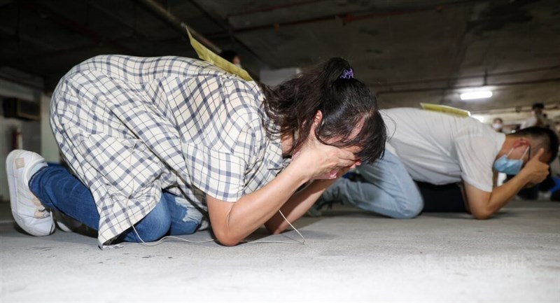 People take the brace position during an air raid drill. CNA file photo