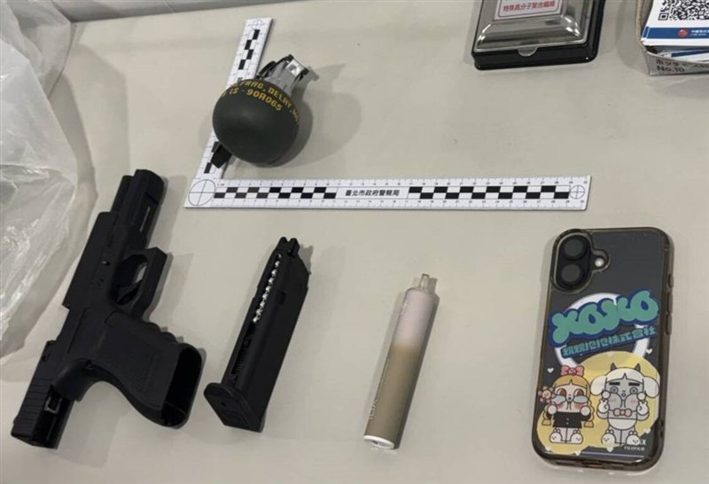 The BB gun and fake grenade used by Lin to rob the CTBC bank are displayed with other items taken into evidence. Photo courtesy of the police