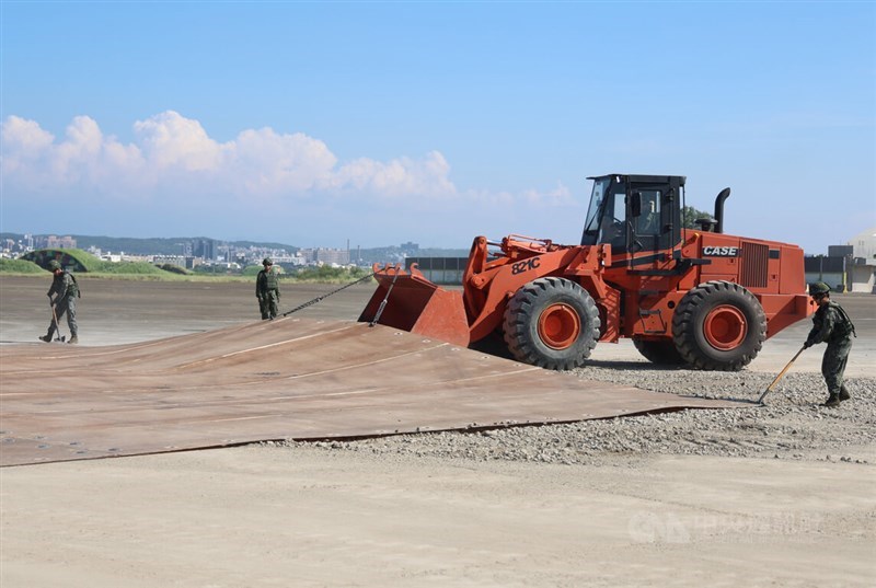 Air Force personnel use heavy machinery to position fiberglass expeditionary runway matting over a repaired mock missile crater at Hsinchu Air Force Base on Friday during Taiwan's Han Kuang 42 military exercises. CNA photo Aug. 7, 2026