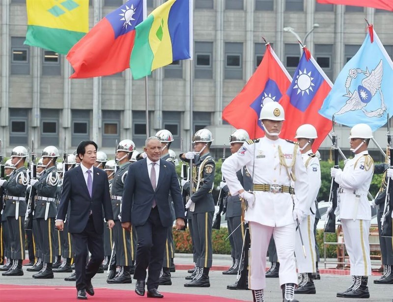 President Lai Ching-te (left) walks with Saint Vincent and the Grenadines Prime Minister Godwin Friday (second left) along a red carpet during a military welcome ceremony in front of the Presidential Office in Taipei on Tuesday. CNA photo Aug. 11, 2026