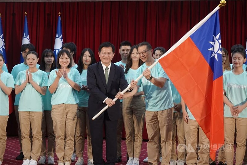 Foreign Minister Lin Chia-lung (fifth left) presents a flag to a group of youth ambassadors in Taipei on Wednesday ahead of their departure for the program. CNA photo Aug. 12, 2026