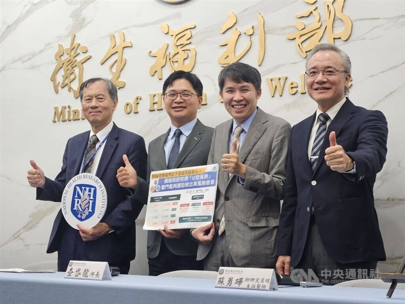 NHRI Cancer Research Institute assistant research fellow and physician Su Yung-yeh (second right) gives a thumbs up alongside colleagues while holding a research chart at a press conference in Taipei on Monday. CNA photo Aug. 17, 2026