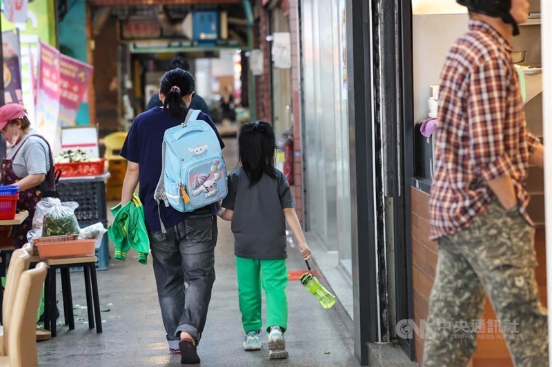 A mother takes her daughter home from school in this CNA file photo for illustrative purposes