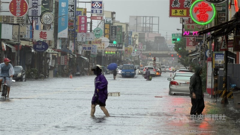 Residents wade through floodwaters about 50 centimeters deep in Donggang Township, Pingtung County, on Monday. CNA photo Aug. 24, 2026