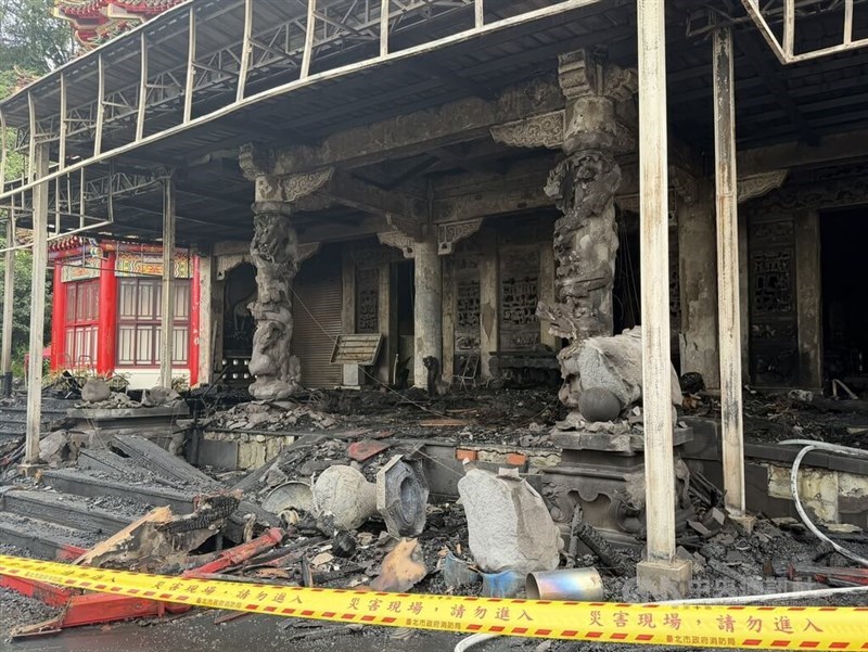 The charred remains of Lingxiao Hall at Chih-Nan Temple stand cordoned off by caution tape in Taipei's Wenshan District on Tuesday. CNA photo Aug. 25, 2026