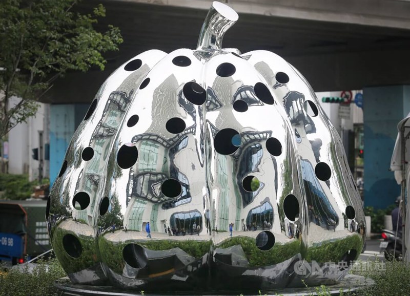 "Pumpkin," a mirror-finished steel sculpture by Kusama, stands at Taipei's Syntrend Creative Park in 2015. The artwork features polka-dot openings that glow purple after dark. CNA file photo