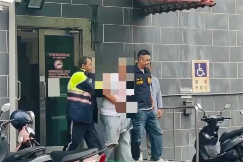 The suspect surnamed Yu (center) is seen being escorted by law enforcement officers on Monday. Photo courtesy of a private contributor