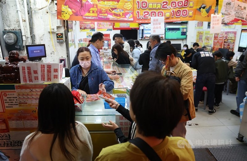 People buy lottery tickets at a lottery shop. CNA file photo